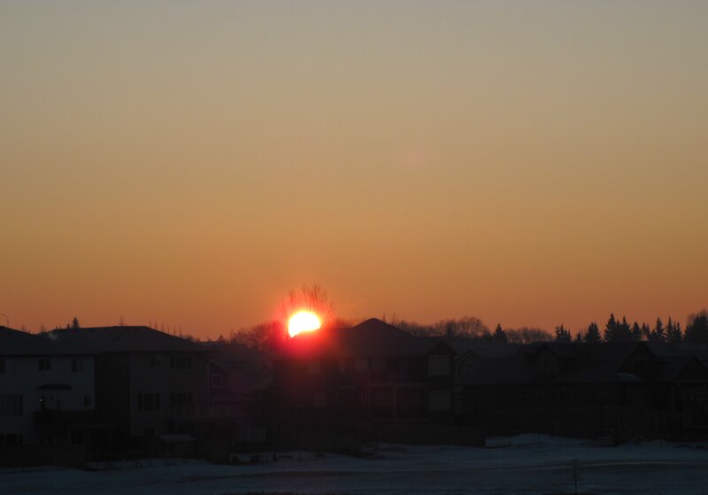 Sun Setting Behind Houses — Orange