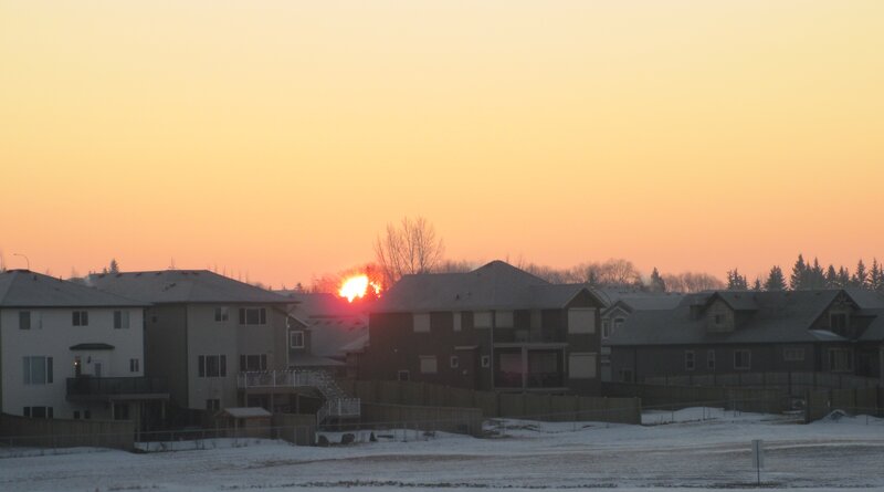 Sun Setting Behind Houses