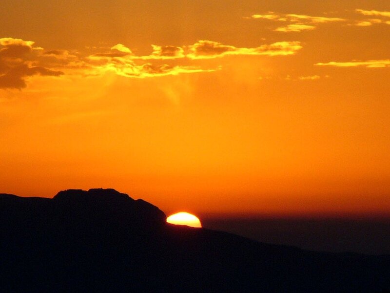 Sun Setting Behind Mountain