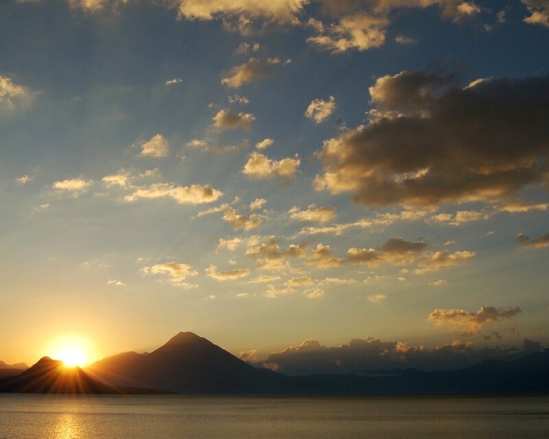 Sun Setting Behind Mountains — Blue, Serene