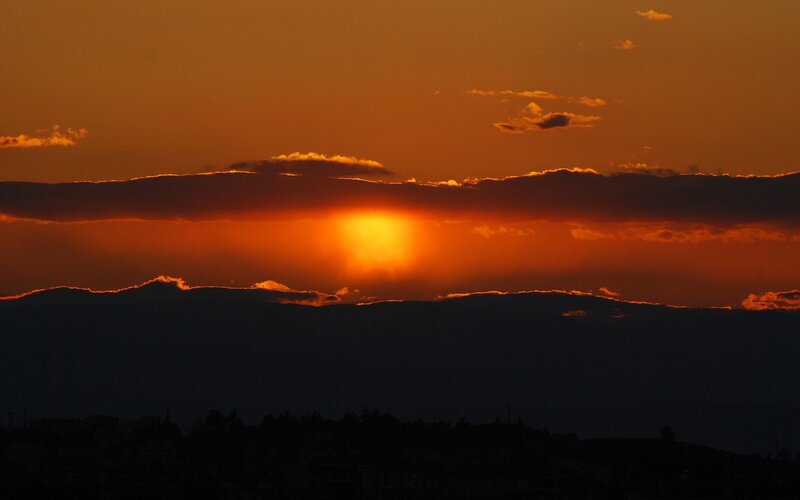 Sun Setting Behind Mountains — Orange, Dramatic, Sunset, Photograph, Clouds, City, Black