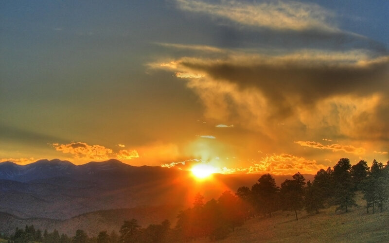 Sun Setting Behind Mountains — Orange, Dramatic, Sunset, Photograph, Trees, Clouds, Yellow, Blue