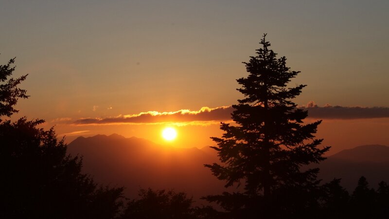 Sun Setting Behind Mountains — Orange, Serene, Sunset, Photograph, Trees, Clouds