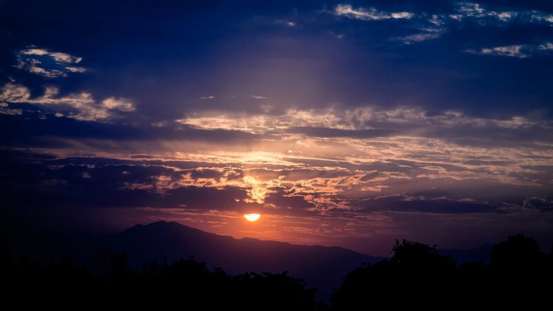 Sun Setting Behind Mountains — Purple, Dramatic