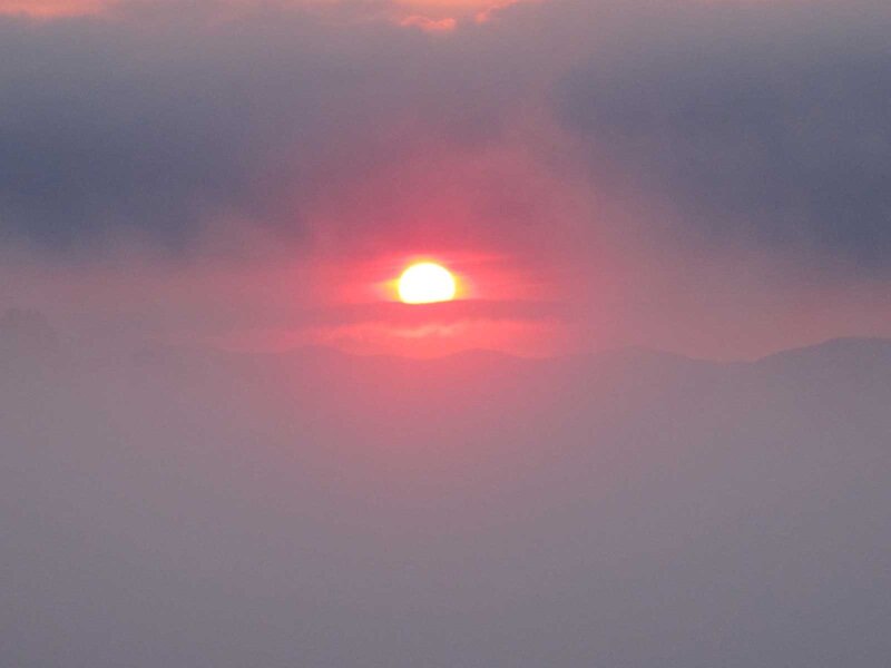 Sun Setting Behind Mountains — Red, Dramatic, Sunset, Photograph, Clouds