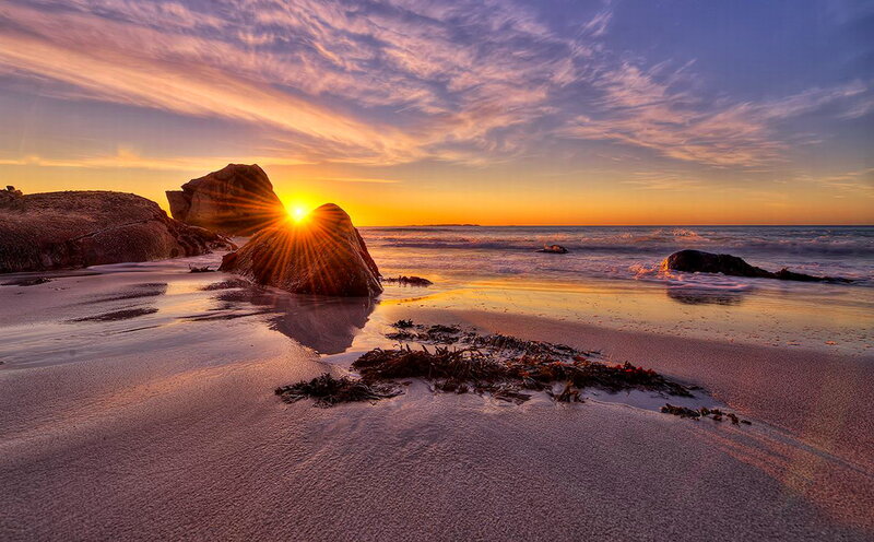 Sun Setting Behind Rocks — Orange