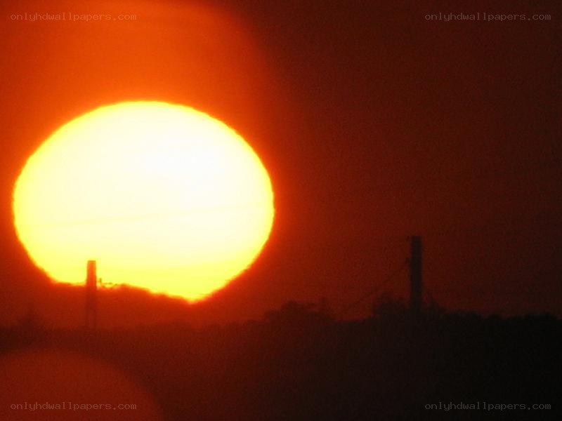 Sun setting behind silhouettes