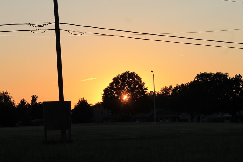 Sun Setting Behind Trees — Orange, Serene, Sunset, Photograph, Power Lines, Street Light