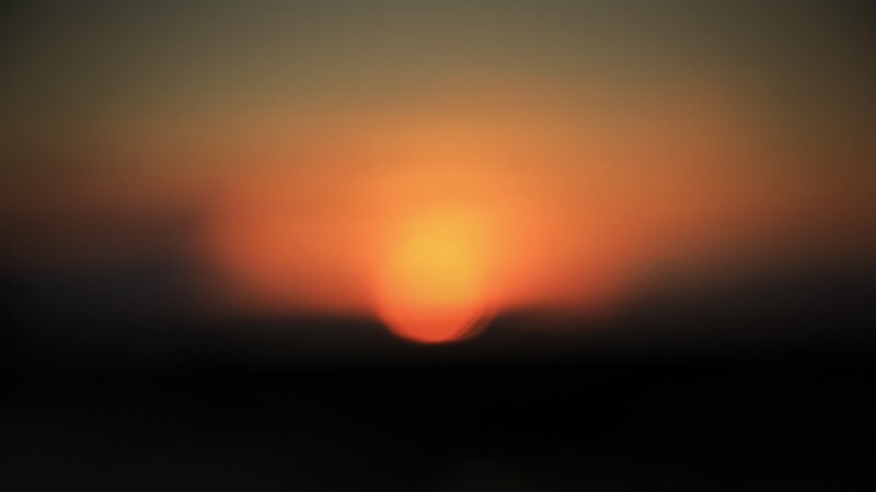 Sun Setting on Horizon — Orange