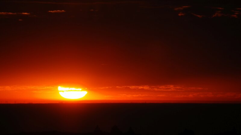 Sun Setting on Horizon — Red