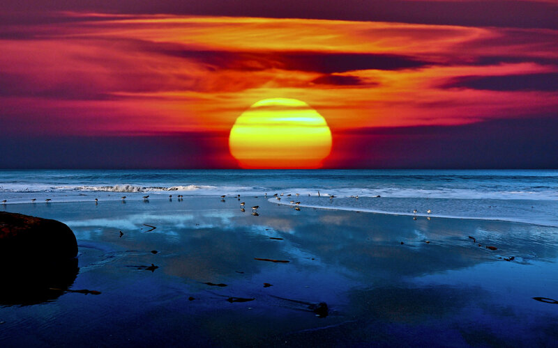 Sun Setting over Beach — Red