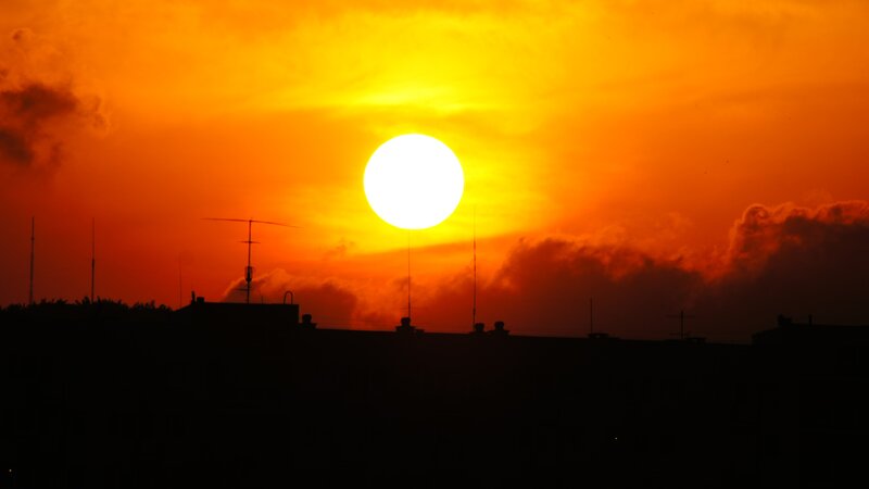 Sun Setting over City — Orange, Dramatic