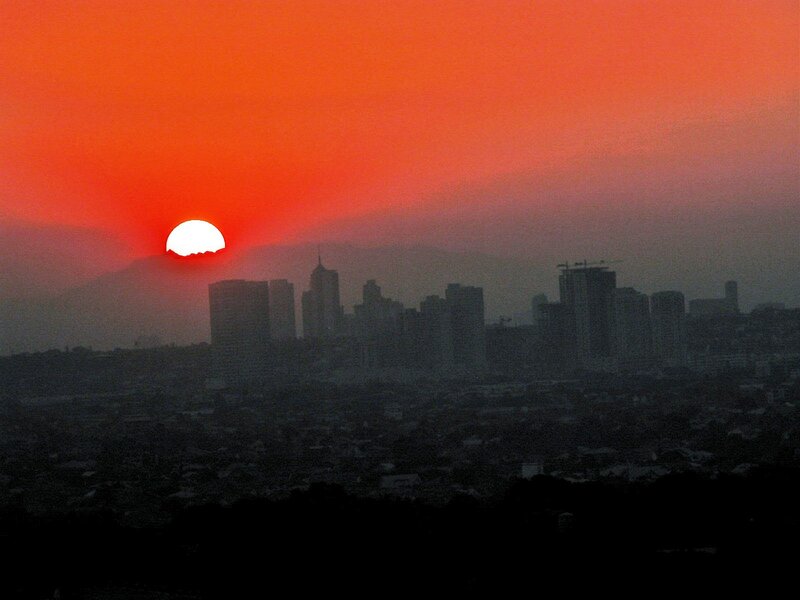 Sun Setting over City — Red