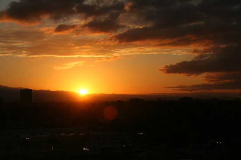 Sun Setting over City