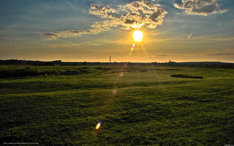 Sun Setting over Grass Field