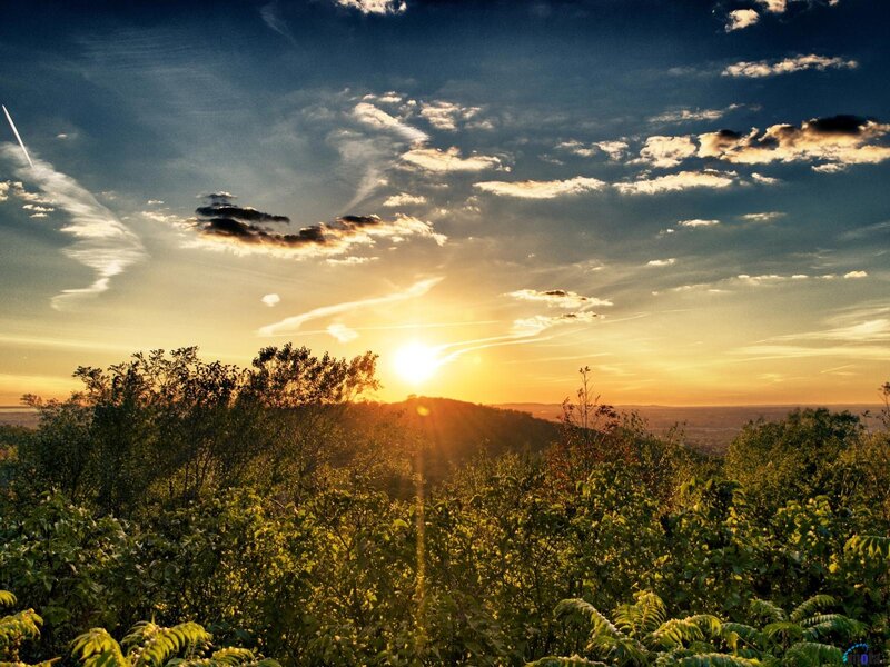 Sun Setting over Hills — Blue