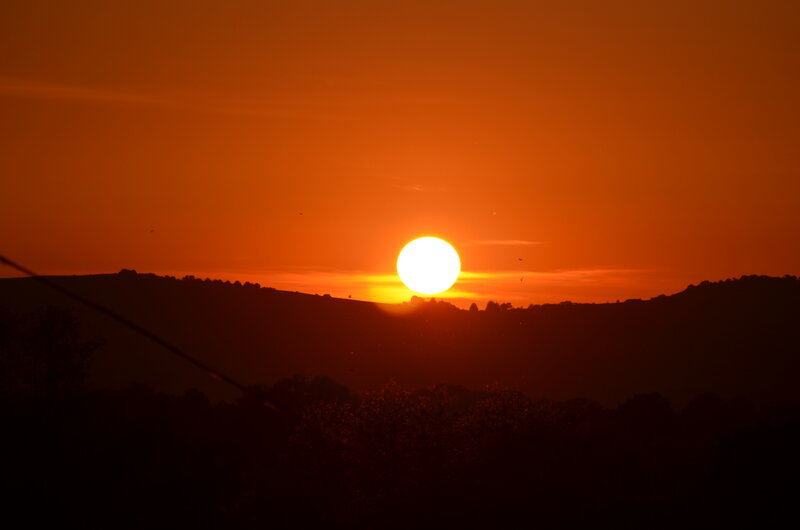 Sun Setting over Hills — Orange, Dramatic, Sunset