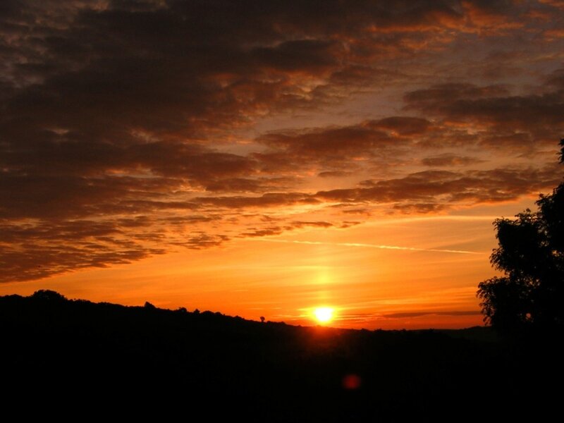 Sun Setting over Hills — Orange