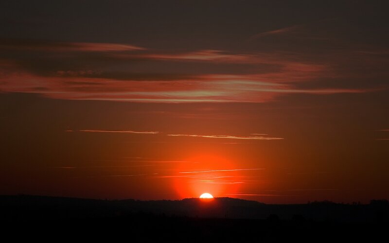 Sun Setting over Hills — Red, Dramatic