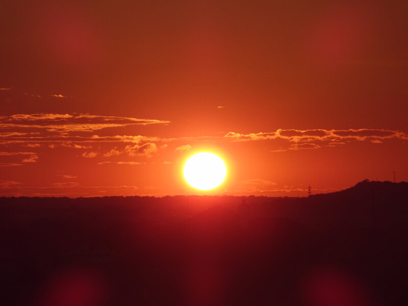 Sun Setting over Hills — Red