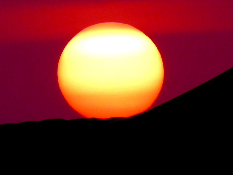 Sun Setting over Horizon