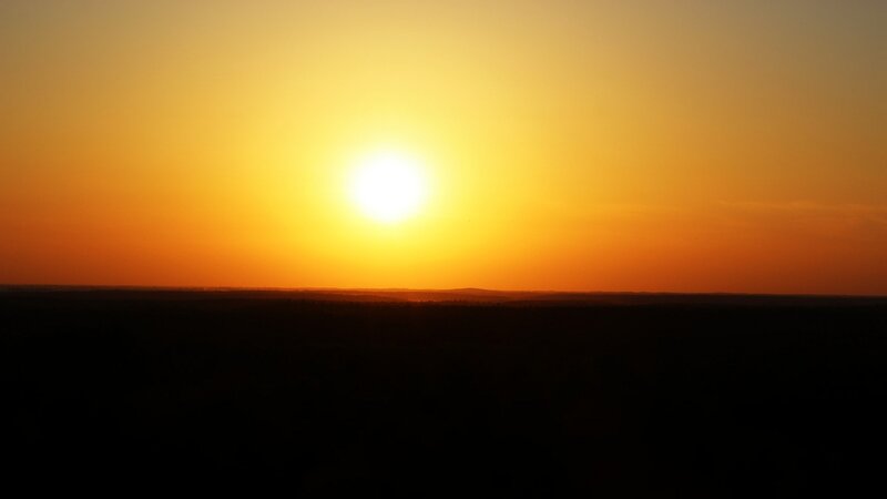 Sun Setting over Horizon — Yellow, Serene