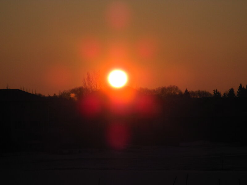 Sun Setting over Houses