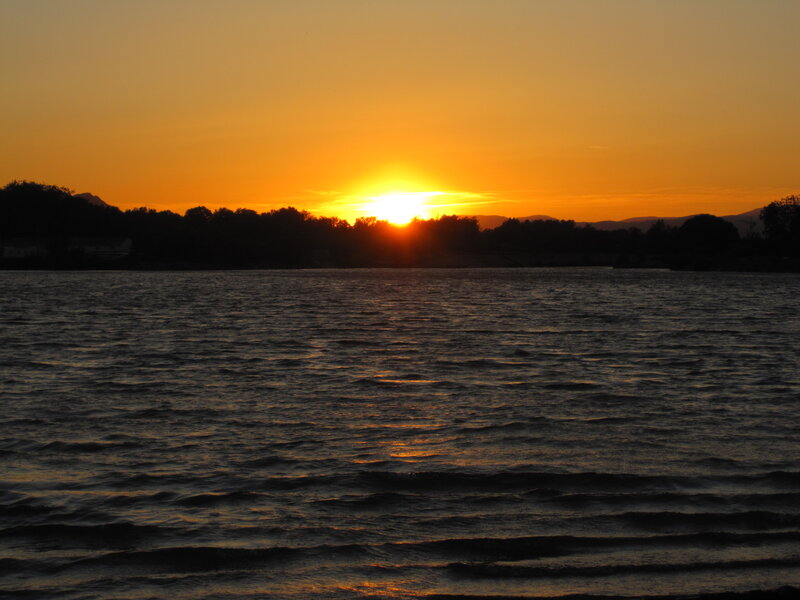 Sun Setting over Lake — Orange, Serene, Sunset, Photograph, Trees, Mountains, Sky