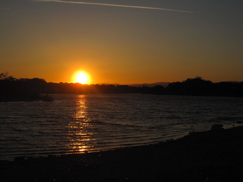Sun Setting over Lake — Orange, Serene, Sunset, Photograph, Trees, Mountains