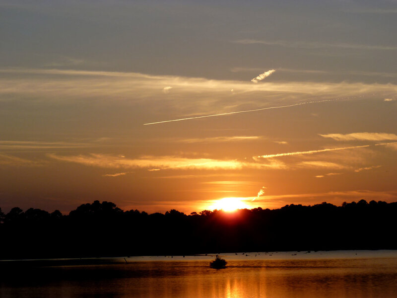 Sun Setting over Lake — Orange, Serene, Sunset, Photograph, Trees, Sky, Boat