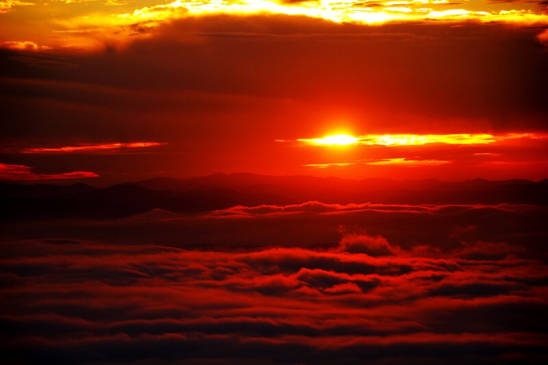 Sun Setting over Mountains — Red