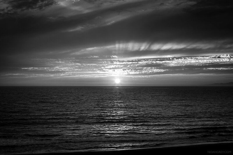 Sun Setting over Ocean — Black, Dramatic, Sunset, Photograph, Clouds