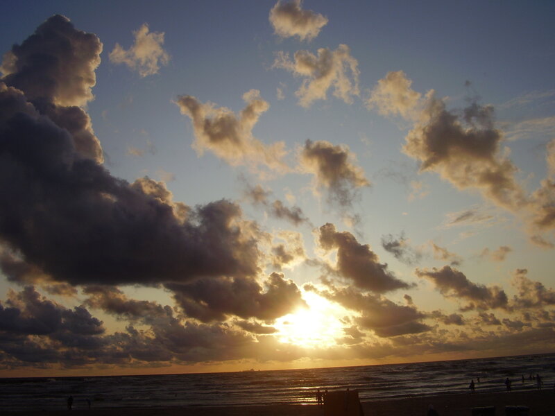 Sun Setting over Ocean — Blue, Dramatic, Sunset, Photograph, Clouds, Beach, People