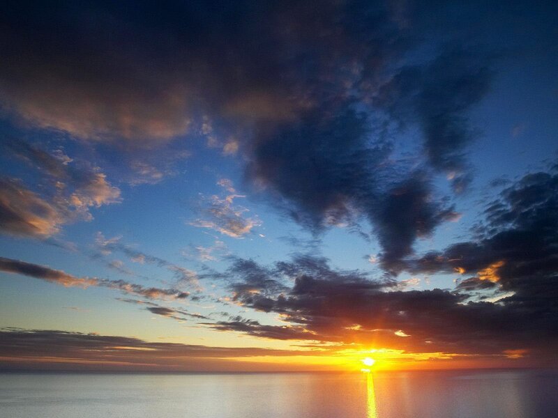 Sun Setting over Ocean — Blue, Dramatic, Sunset, Photograph, Clouds, Orange, Yellow