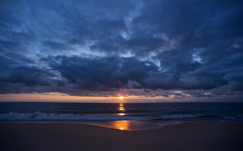 Sun Setting over Ocean — Blue, Dramatic, Sunset, Photograph, Clouds, Sand, Waves, Orange, Black
