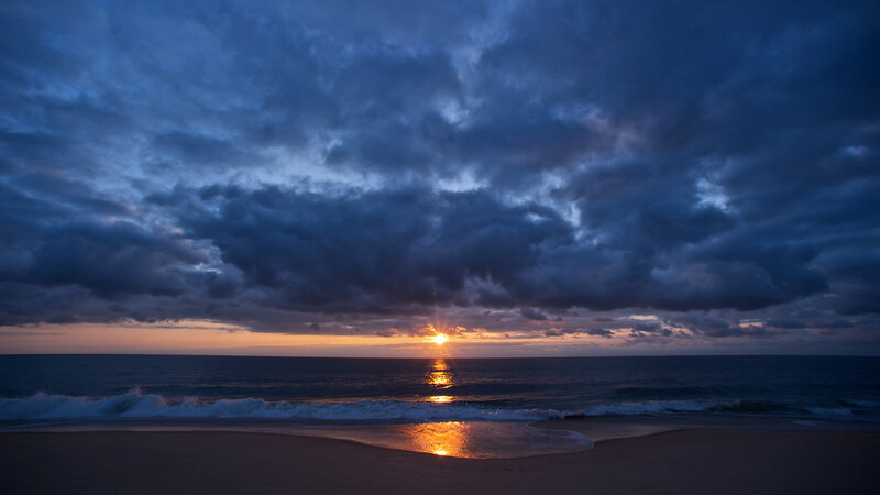 Sun Setting over Ocean — Blue, Dramatic, Sunset, Photograph, Clouds, Sand, Waves