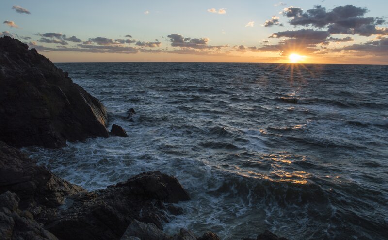 Sun Setting over Ocean — Blue, Dramatic, Sunset, Photograph, Rocks