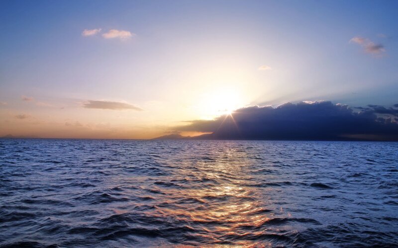 Sun Setting over Ocean — Blue, Serene, Sunset, Photograph, Clouds, Mountain, Orange, Yellow