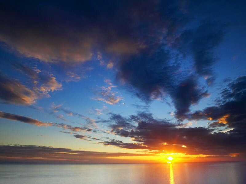 Sun Setting over Ocean — Blue, Serene, Sunset, Photograph, Clouds, Sky, Sea