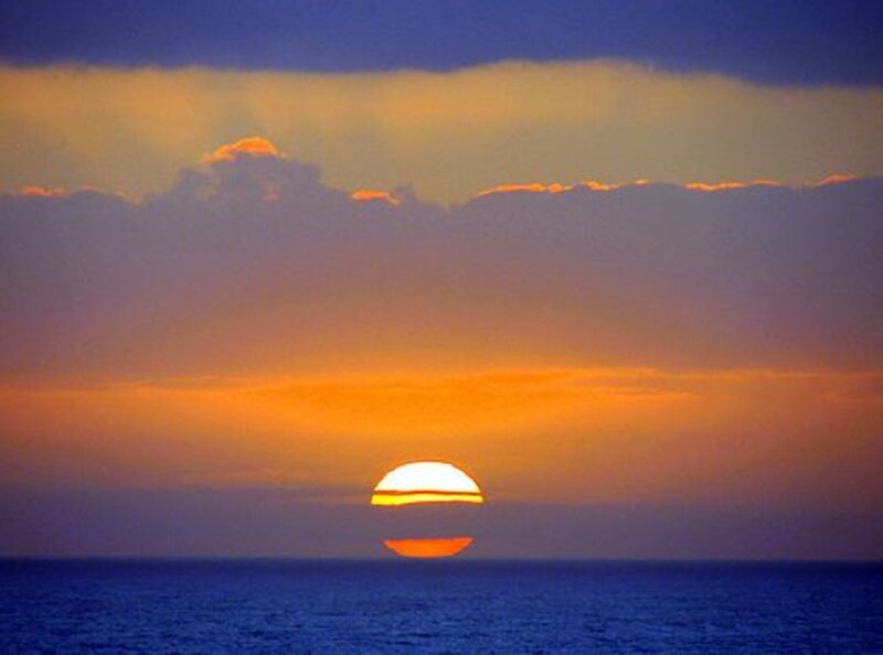 Sun Setting over Ocean — Blue, Serene, Sunset, Photograph, Clouds, Sky