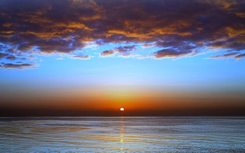 Sun Setting over Ocean — Blue, Serene, Sunset, Photograph, Clouds