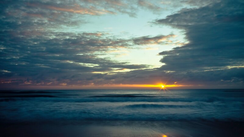 Sun Setting over Ocean — Blue, Serene, Sunset, Photograph, Clouds, Waves, Horizon, Orange