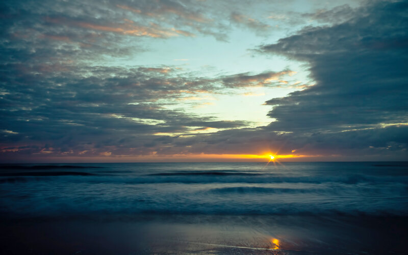Sun Setting over Ocean — Blue, Serene, Sunset, Photograph, Clouds, Waves