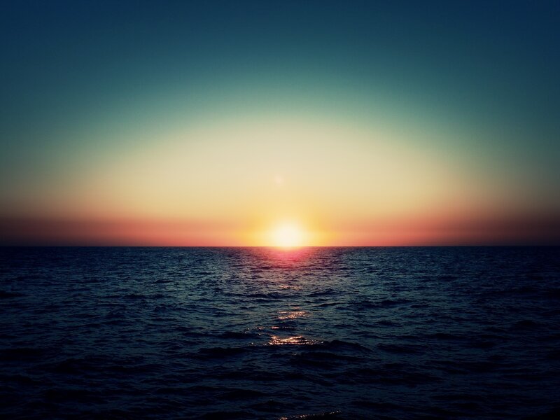 Sun Setting over Ocean — Blue, Serene, Sunset, Photograph, Horizon, Yellow