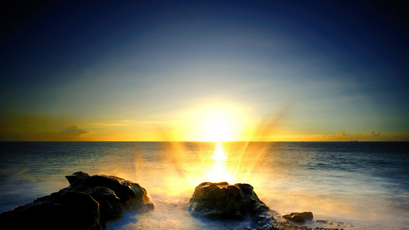 Sun Setting over Ocean — Blue, Serene, Sunset, Photograph, Rocks, Sea
