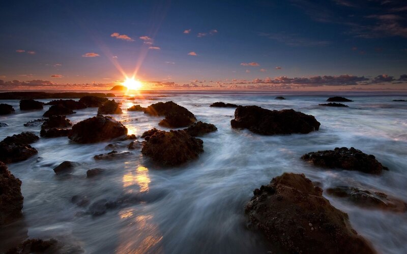 Sun Setting over Ocean — Blue, Serene, Sunset, Photograph, Rocks, Waves
