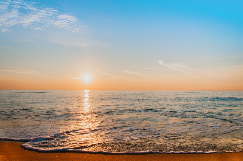 Sun Setting over Ocean — Blue, Serene, Sunset, Photograph, Sand