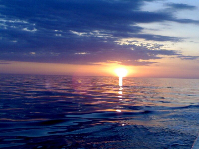 Sun Setting over Ocean — Blue, Serene, Sunset, Photograph, Sky, Clouds, Reflection