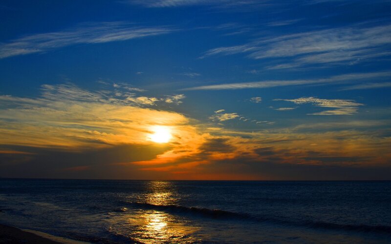 Sun Setting over Ocean — Blue, Serene, Sunset, Photograph, Sky, Clouds