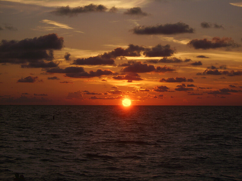 Sun Setting over Ocean — Dramatic, Dark Blue